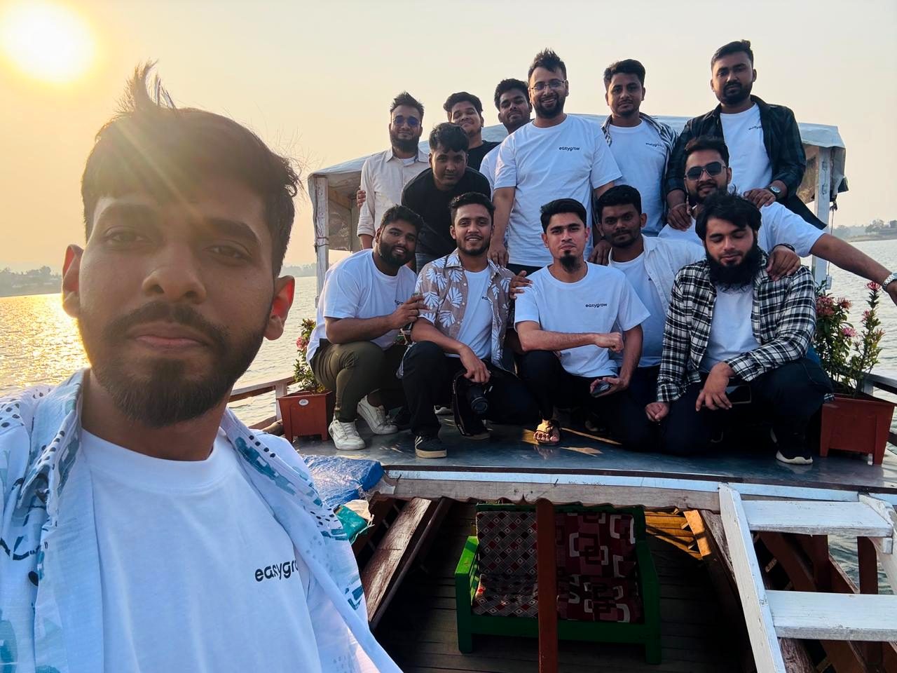 The EasyGrow Digital team together on a boat deck at sunset during the Annual Refreshment Tour 2026 in Rangamati